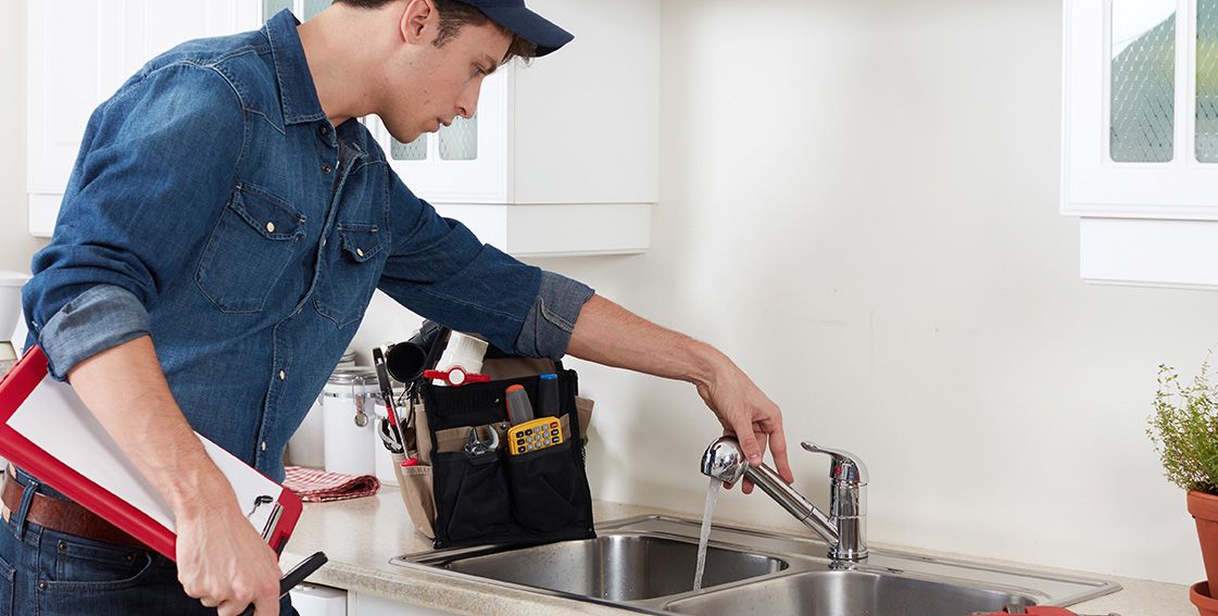 Plumber Checking Kitchen Sink Faucet